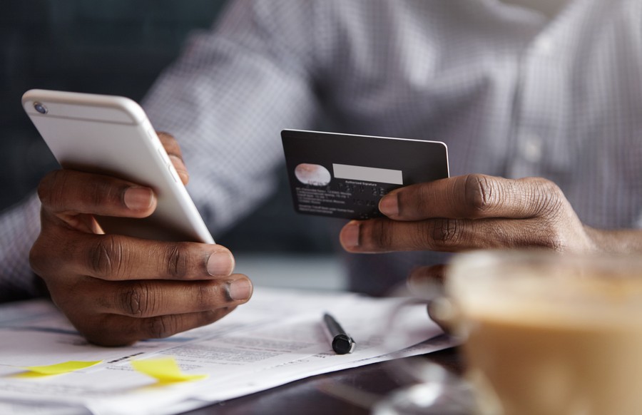 Business owner processing a secure payment on a phone and card